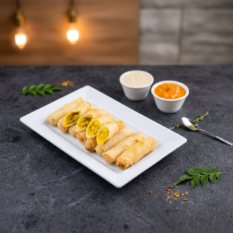 Crispy golden dosa rolls by RLS Foods, cut open to reveal a savory spiced potato filling, served with coconut and tomato chutneys.